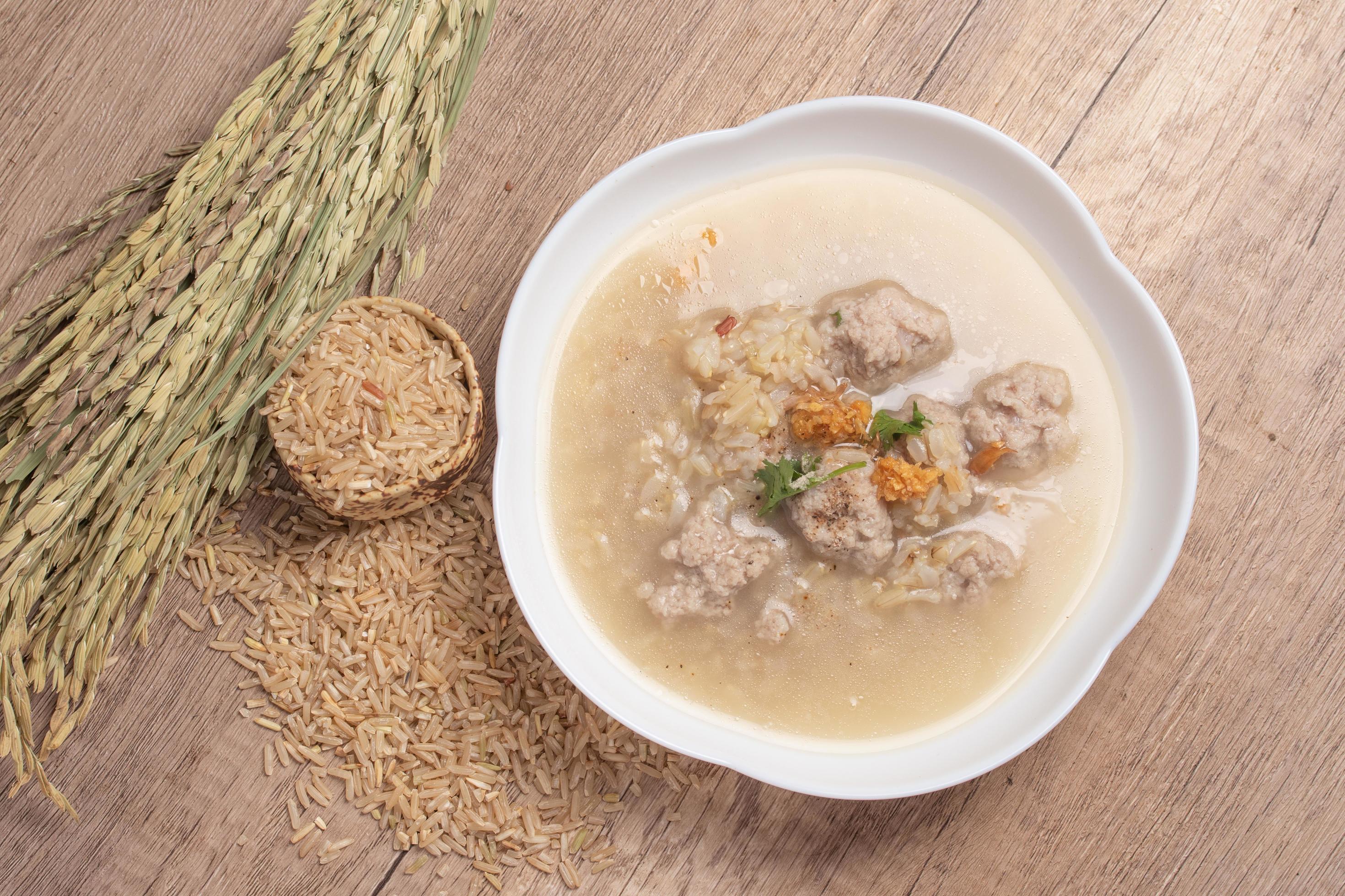 Jasmine brown rice porridge with pork on wooden background.Healthy food copy space Stock Free