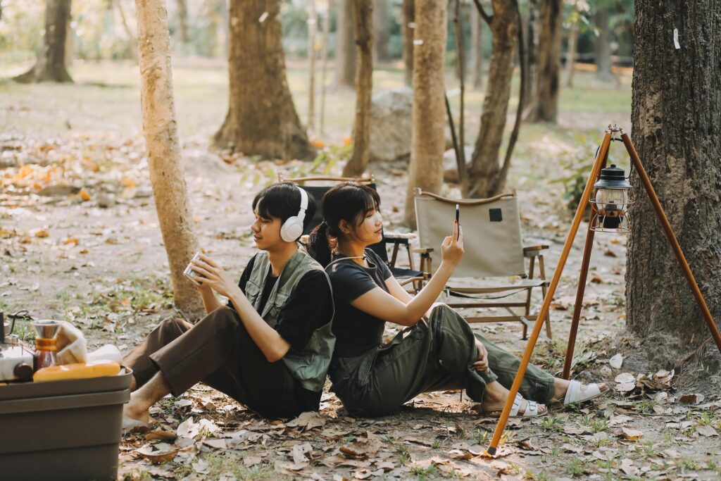 Asian couple sweet in tent inside on they camping trip, traveller relax and sleep togather in out door and camping trip Stock Free