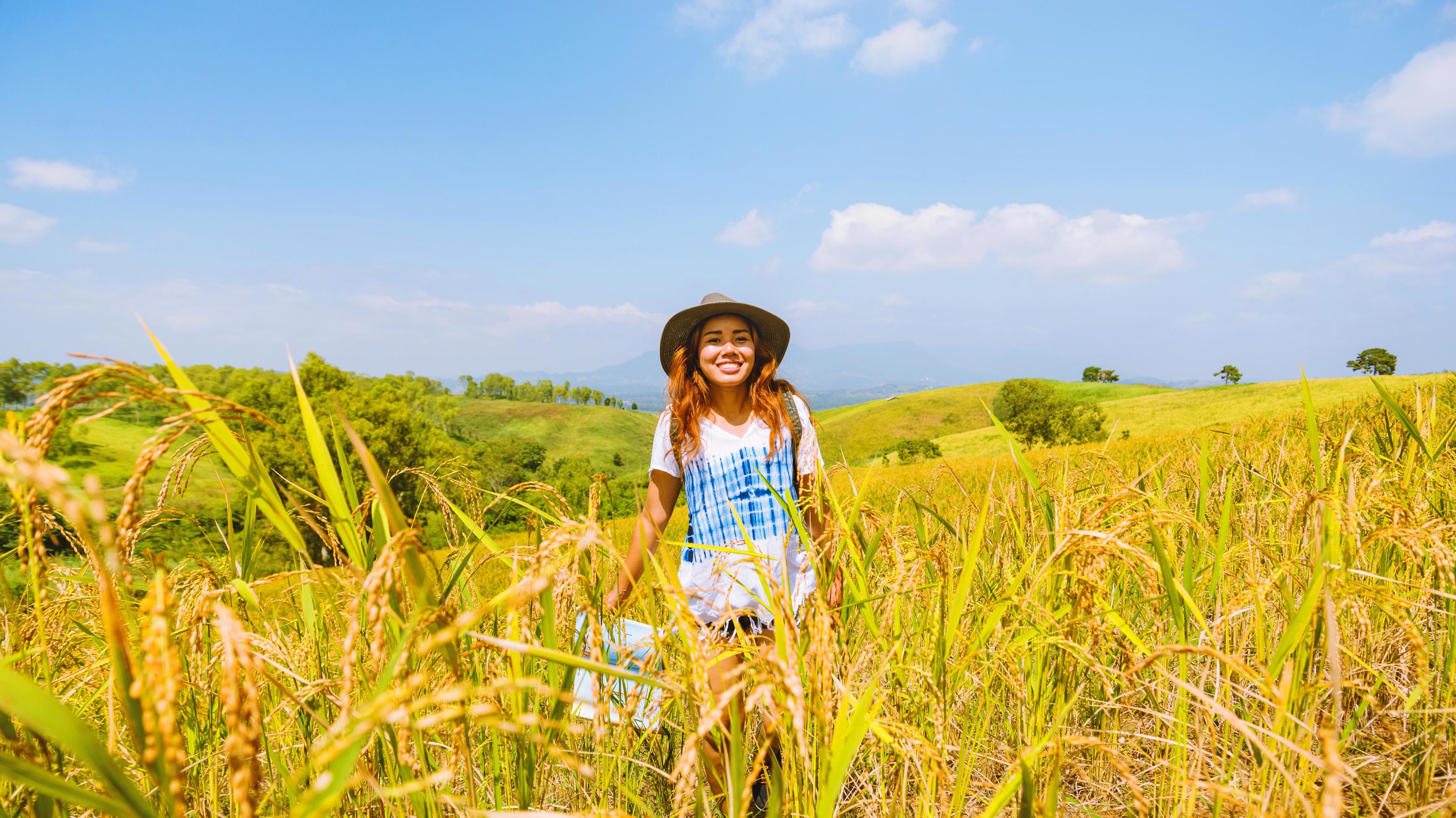 Asian women travel relax in the holiday. Stand natural touch mountain field summer. View map travel explore. In Thailand Stock Free