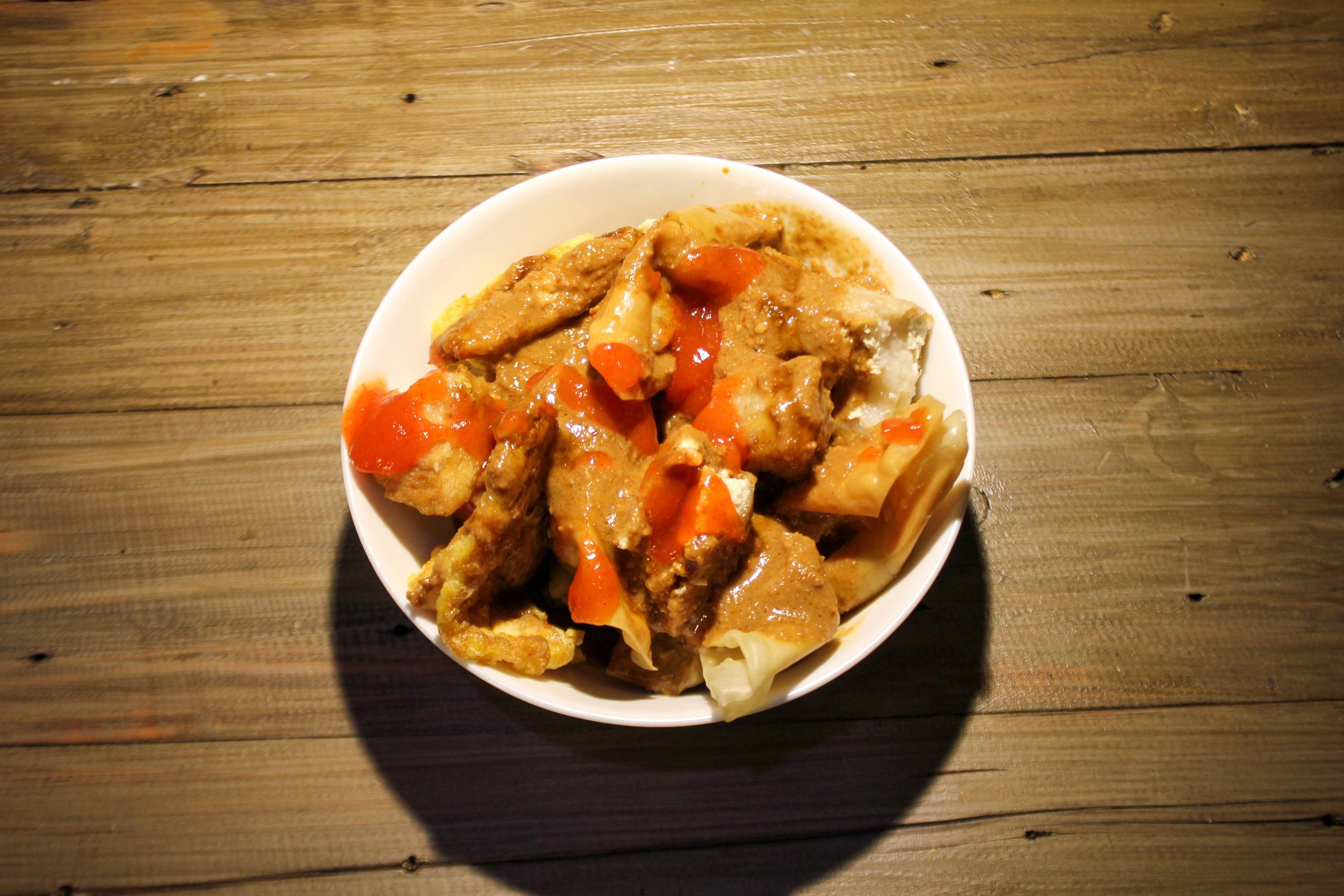 fried batagor on a white bowl. batagor is an Indonesian snack food, usually enjoyed with the addition of peanut sauce, soy sauce and chili sauce. Stock Free