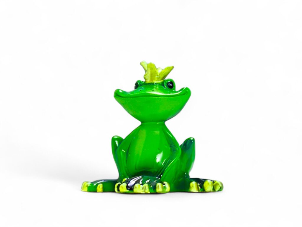 Miniature green frog animal wearing a crown on a white background Stock Free