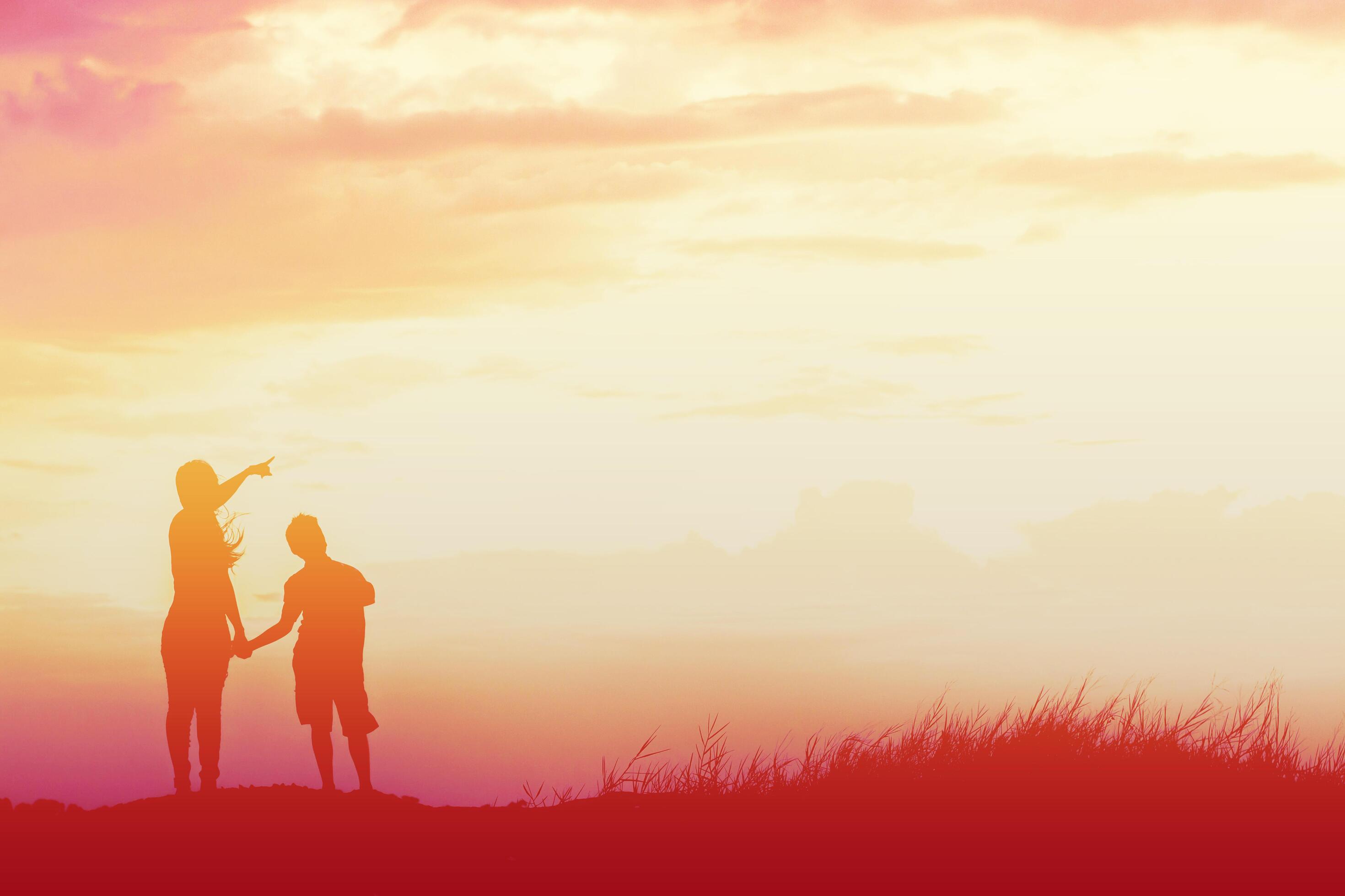 Mother encouraged her son outdoors at sunset, silhouette concept Stock Free