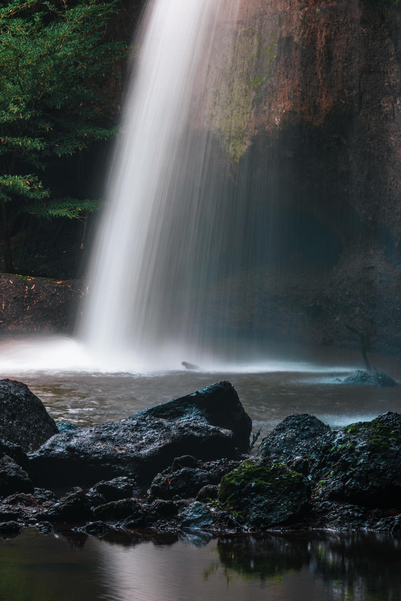 A natural waterfall in a big forest in the midst of beautiful nature. Stock Free