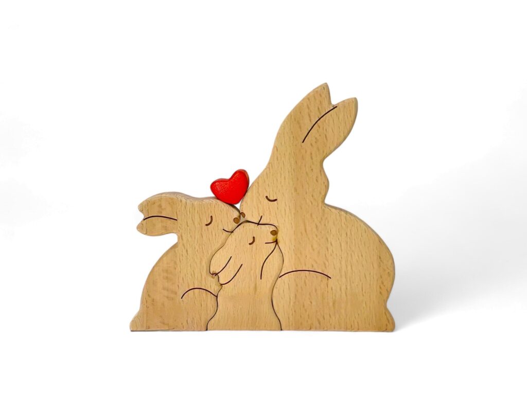 miniature rabbit family decoration made of wood on a white background Stock Free