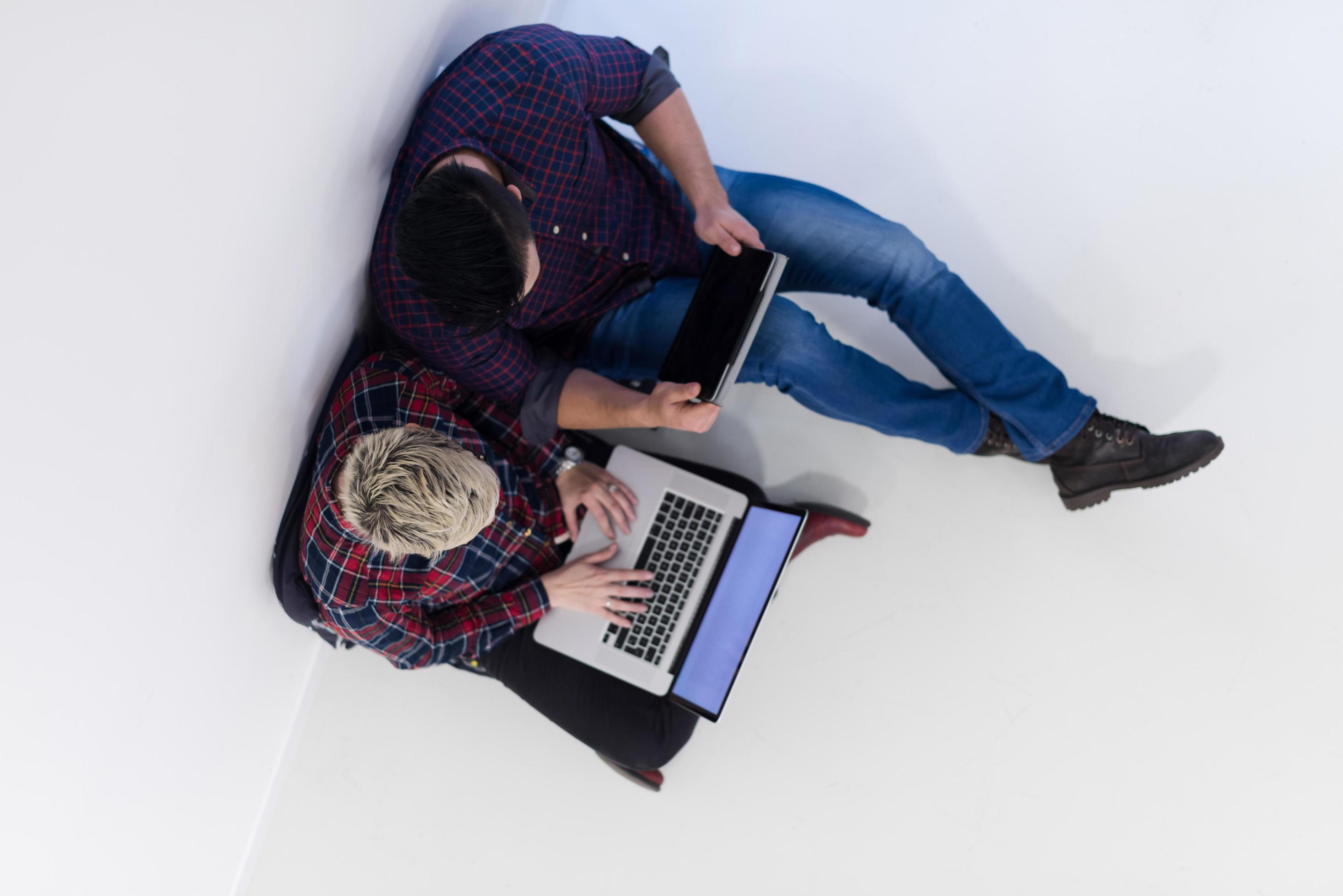 top view of couple working on laptop computer at startup office Stock Free