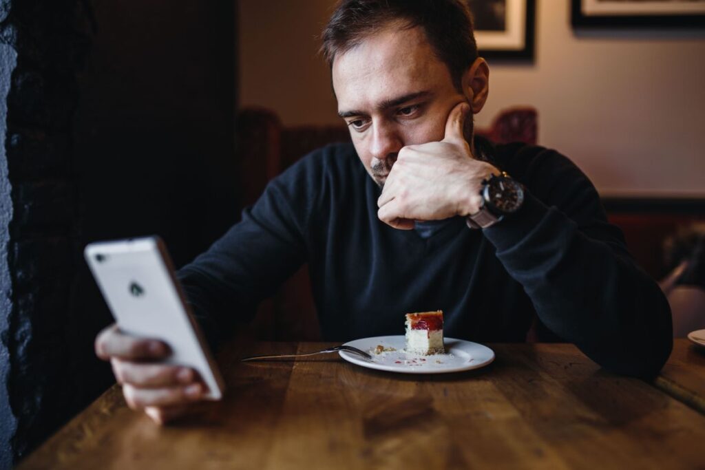 Young Elegantly dressed man sititng in a cafe Stock Free