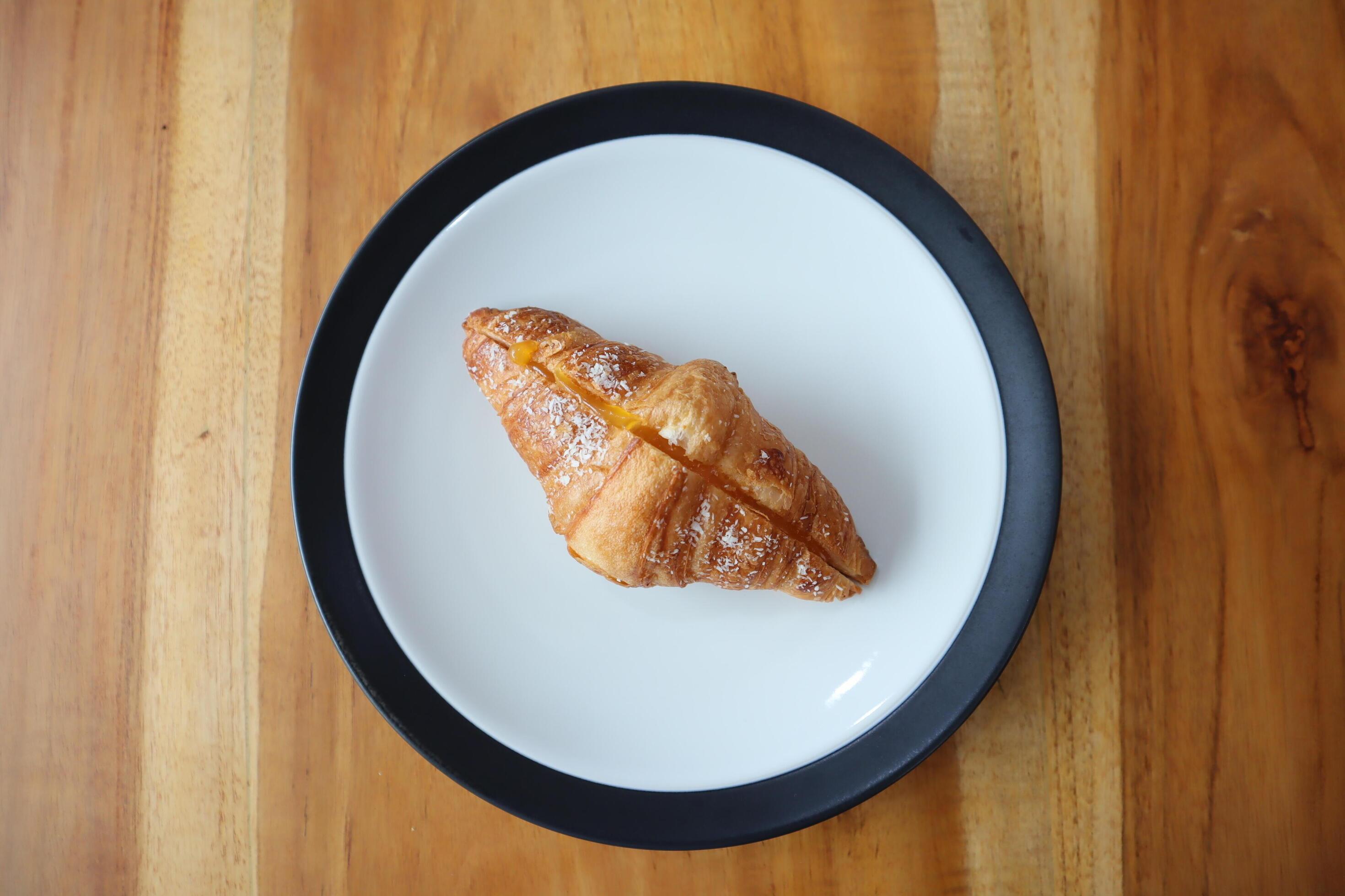 A plate of smoked beef croissants on the table background Stock Free