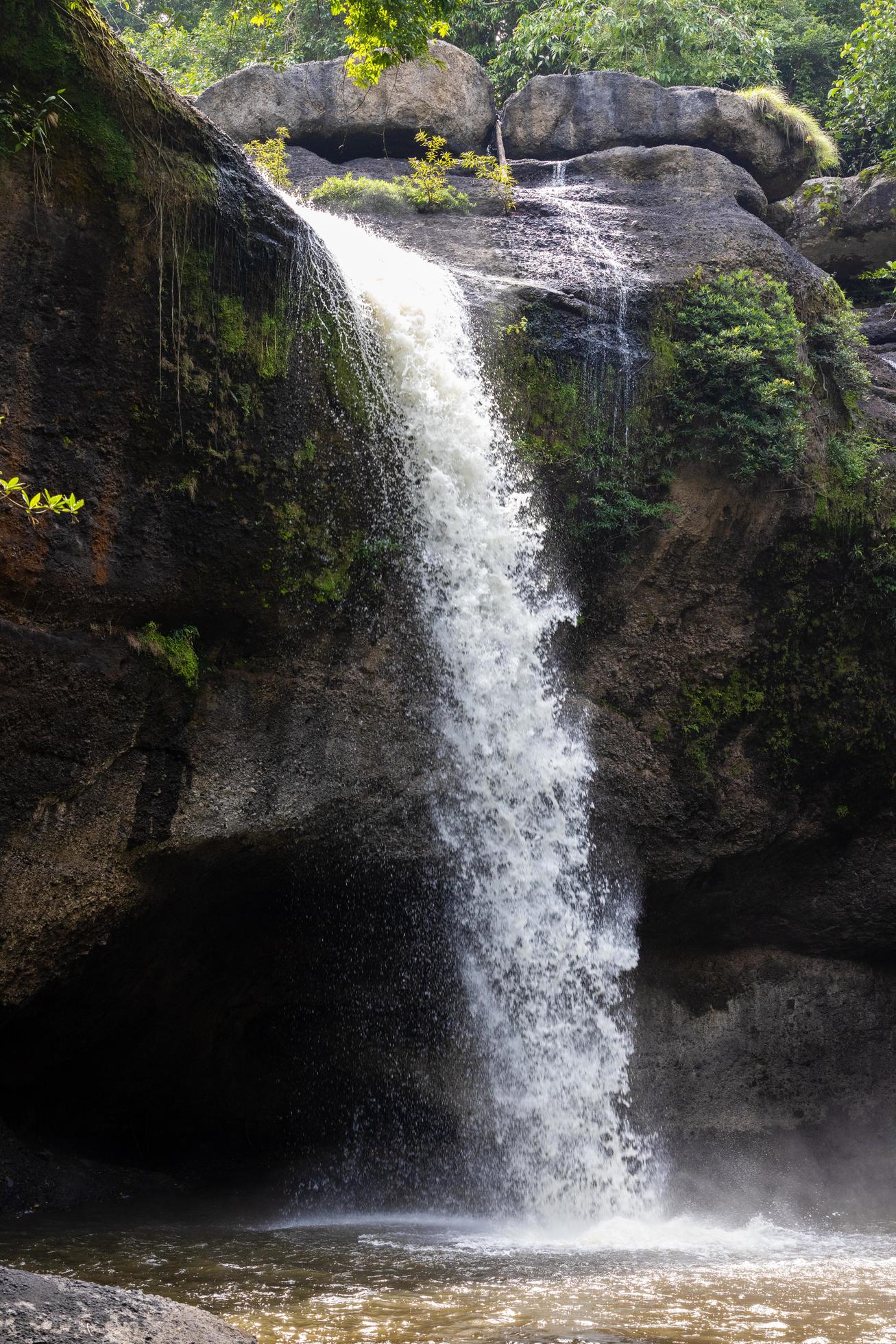 A natural waterfall in a big forest in the midst of beautiful nature. Stock Free