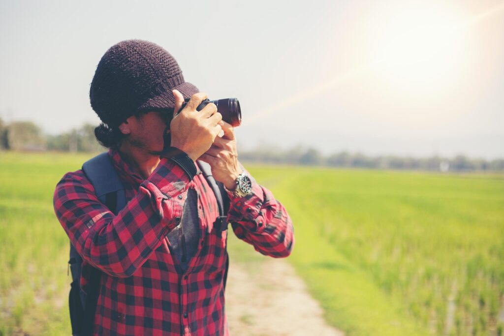 Asian men backpacks and traveler walking together and happy are taking photo on mountain ,Relax time on holiday concept travel,Blurry and soft focus Stock Free