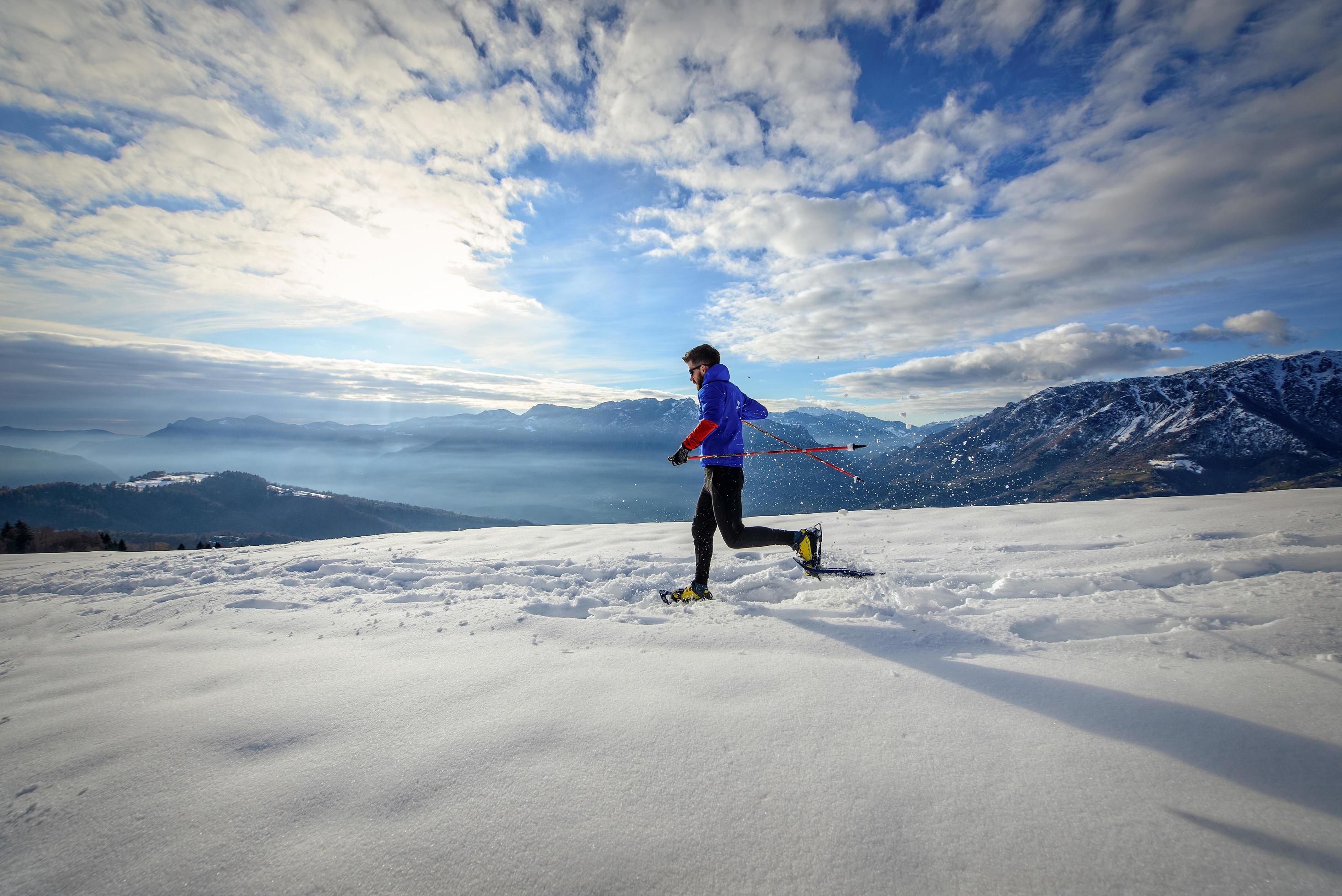 Immersed in alpine nature with snowshoes at sunset Stock Free