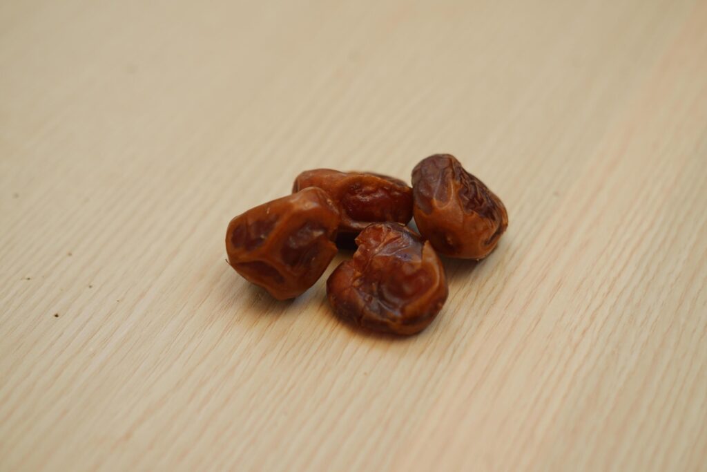 Dates fruit on wooden background. Healthy eating and dieting concept. Stock Free