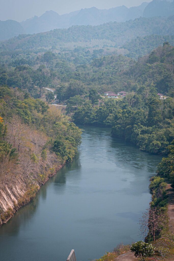 An aerial view of the dam-caused canal in Thailand’s national park, with a mountain the background. Bird eye view. Stock Free