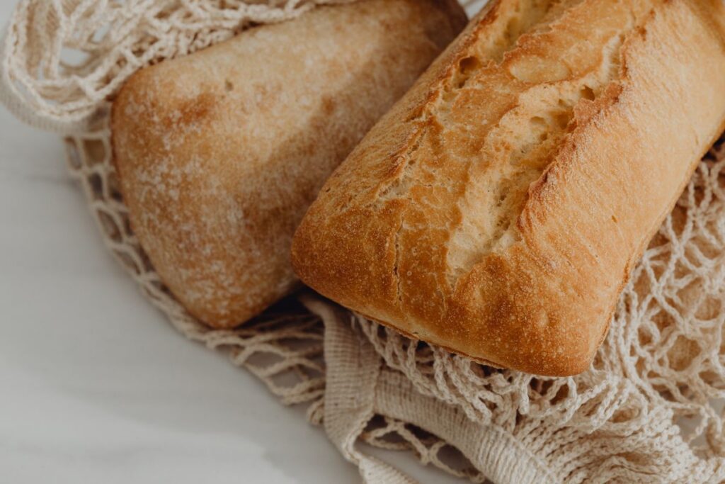 Fresh bread on the kitchen counter – ciabatta – baguette Stock Free