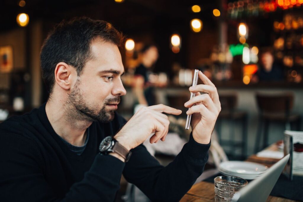 Young Entrepreneur Working from a Modern Cafe Stock Free