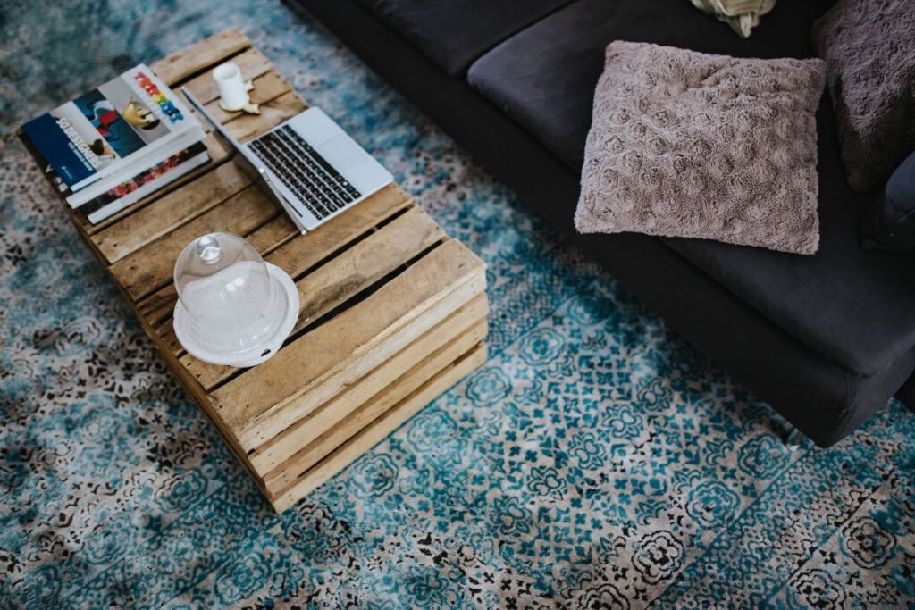 Designer living room interior with a wooden box table and a light blue carpet Stock Free