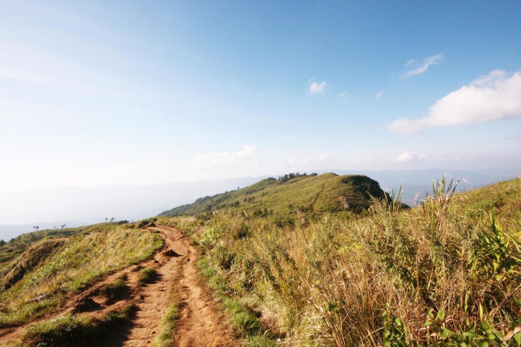 Natural footpath and dry grassland on the mountain with blue sky at Phu Chee Fah hill northern of Thailand Stock Free