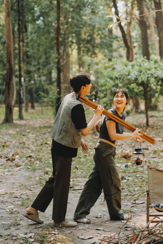 Asian couple sweet in tent inside on they camping trip, traveller relax and sleep togather in out door and camping trip Stock Free