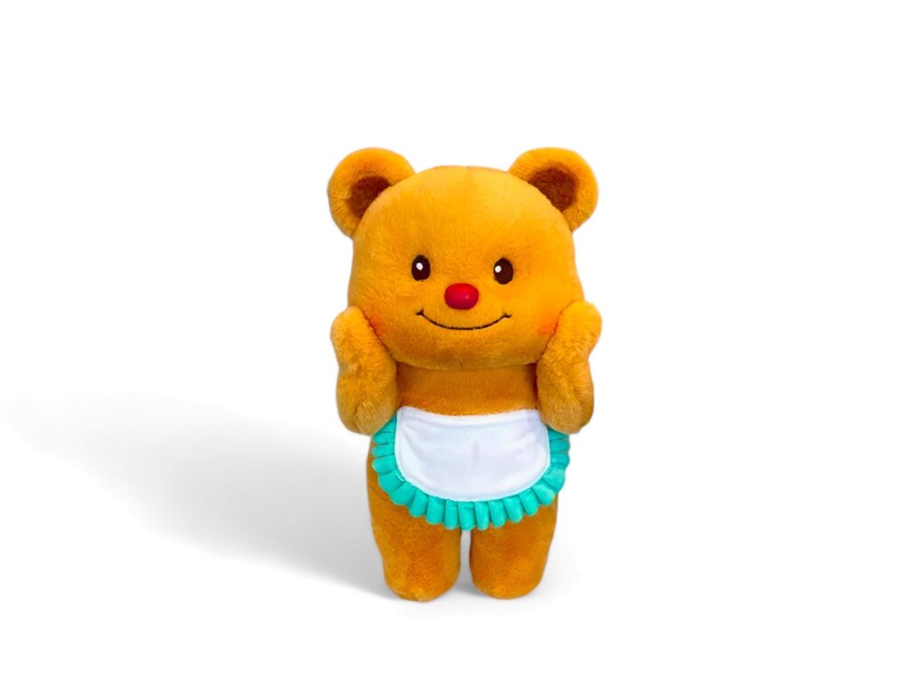 Cute teddy bear wearing an apron on a white background Stock Free