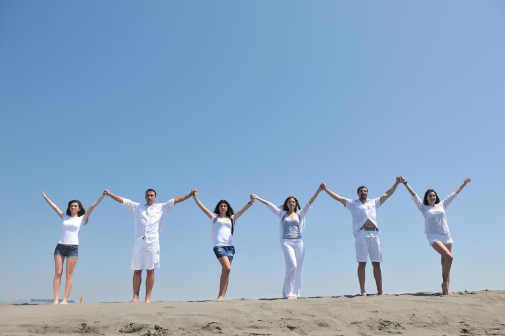 happy people group have fun and running on beach Stock Free