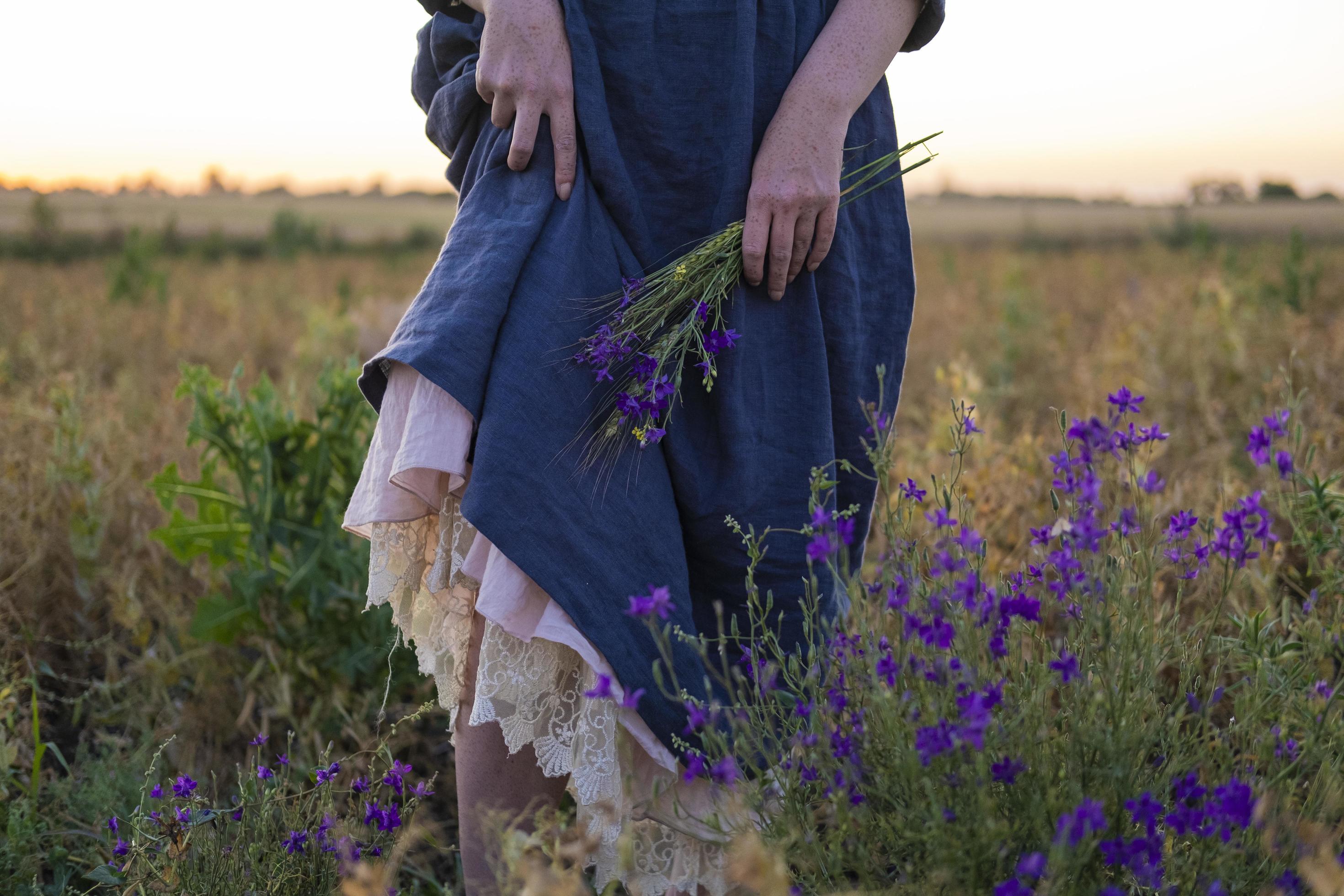 Young redhead woman with freckles in vintage handmade dress walk in fields with flowers Stock Free