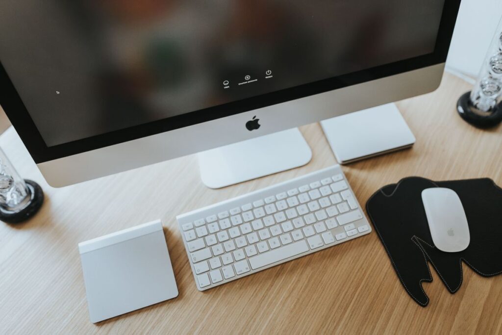 White Apple iMac computer with elephant mousepad Stock Free