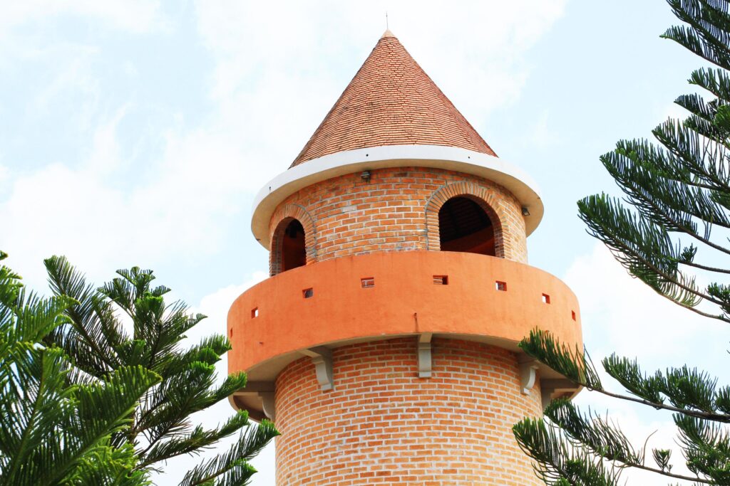 Beautiful brick stone tower is architecture roman stytle landmark in the garden and park at Thailand. Stock Free