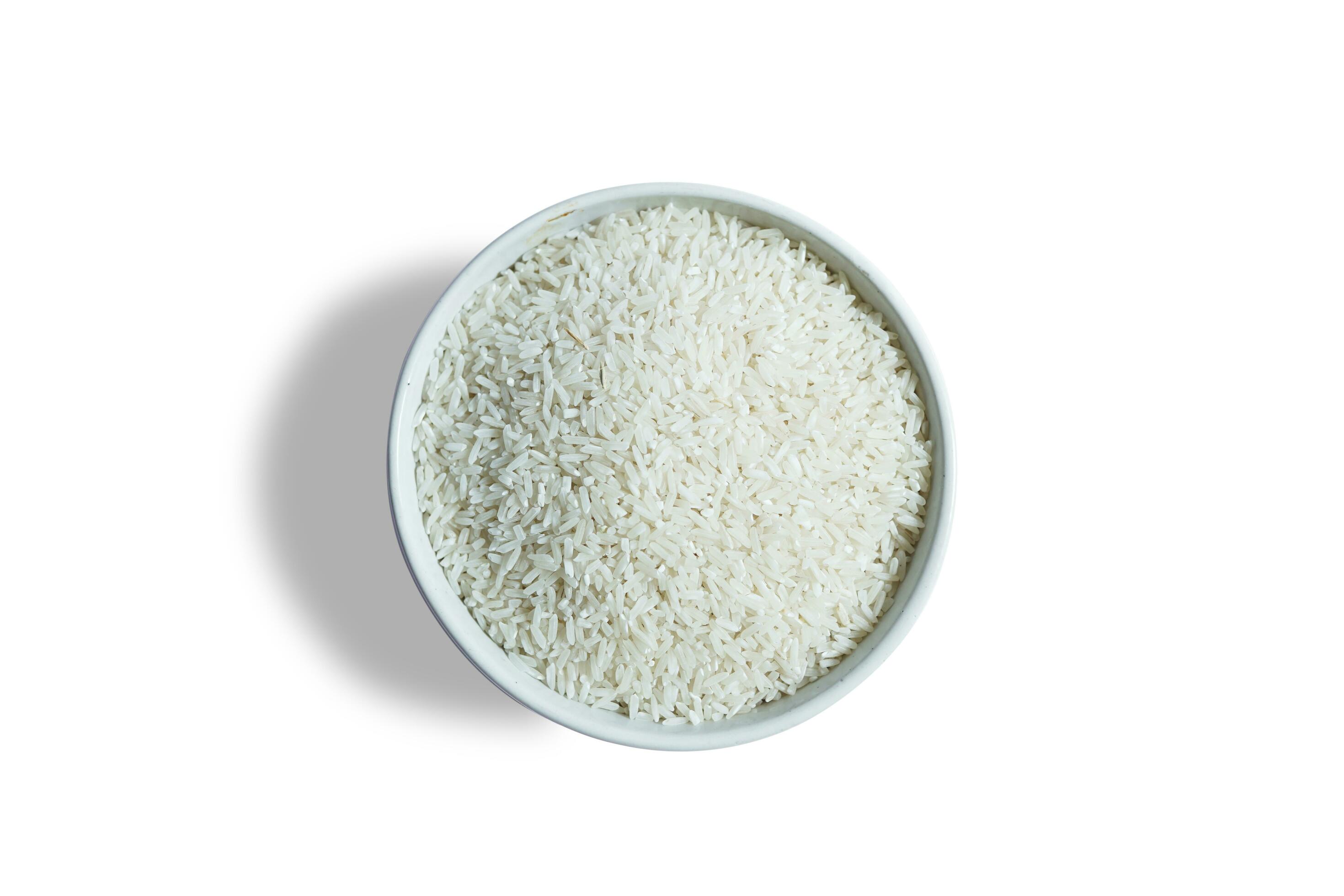 Healthy food. White ceramic bowl with high carb rice on white background. Top view, high resolution product. Stock Free