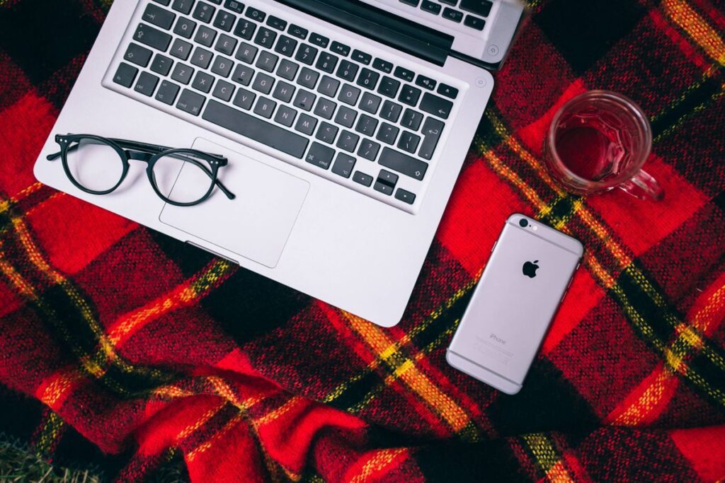 Apple Macbook on a red blanket Stock Free