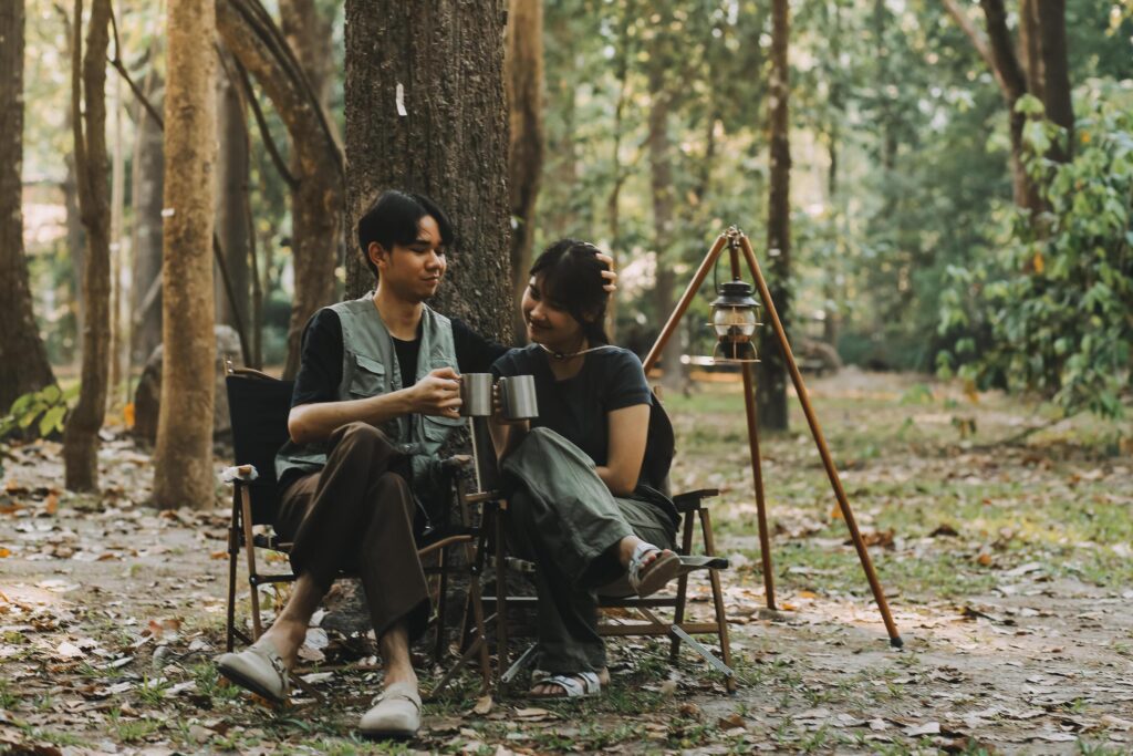 Asian couple sweet in tent inside on they camping trip, traveller relax and sleep togather in out door and camping trip Stock Free