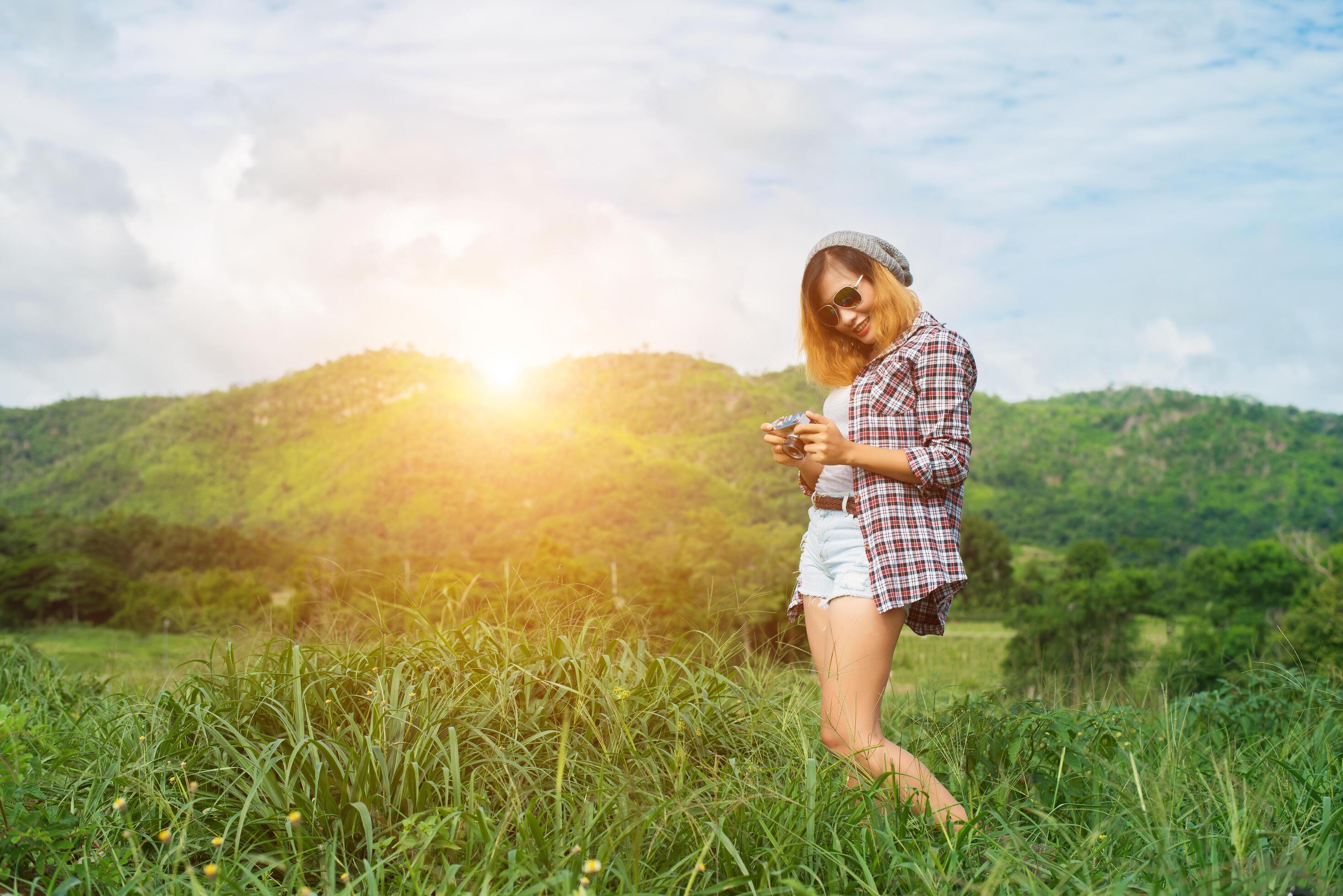 Young Hipster Woman with retro camera taking shot outdoor landscape ,Lifestyle mountain nature on background. Stock Free