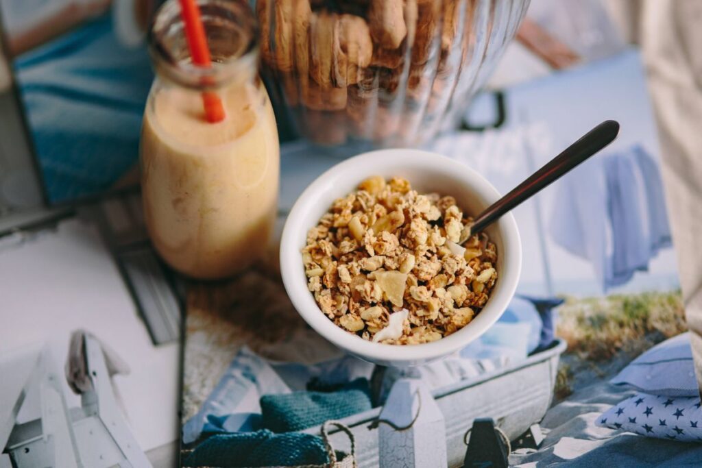 Jar full of walnuts with a fresh healthy shake and musli in a bowl Stock Free