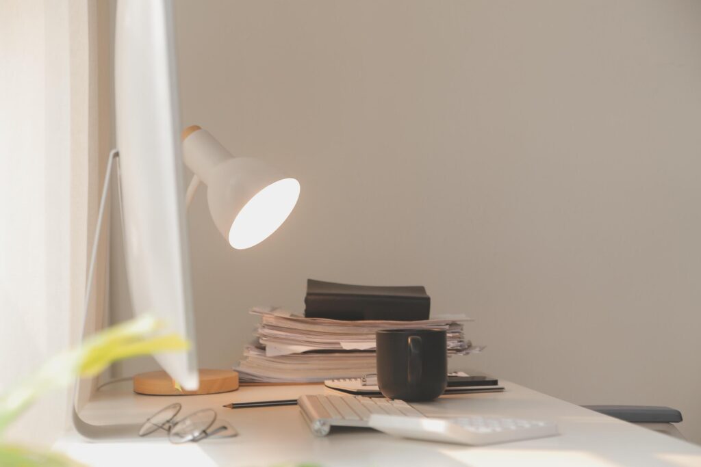 messy office workspace. Messy and cluttered office desk. Messy business office with piles of files and disorganized clutter. Stock Free