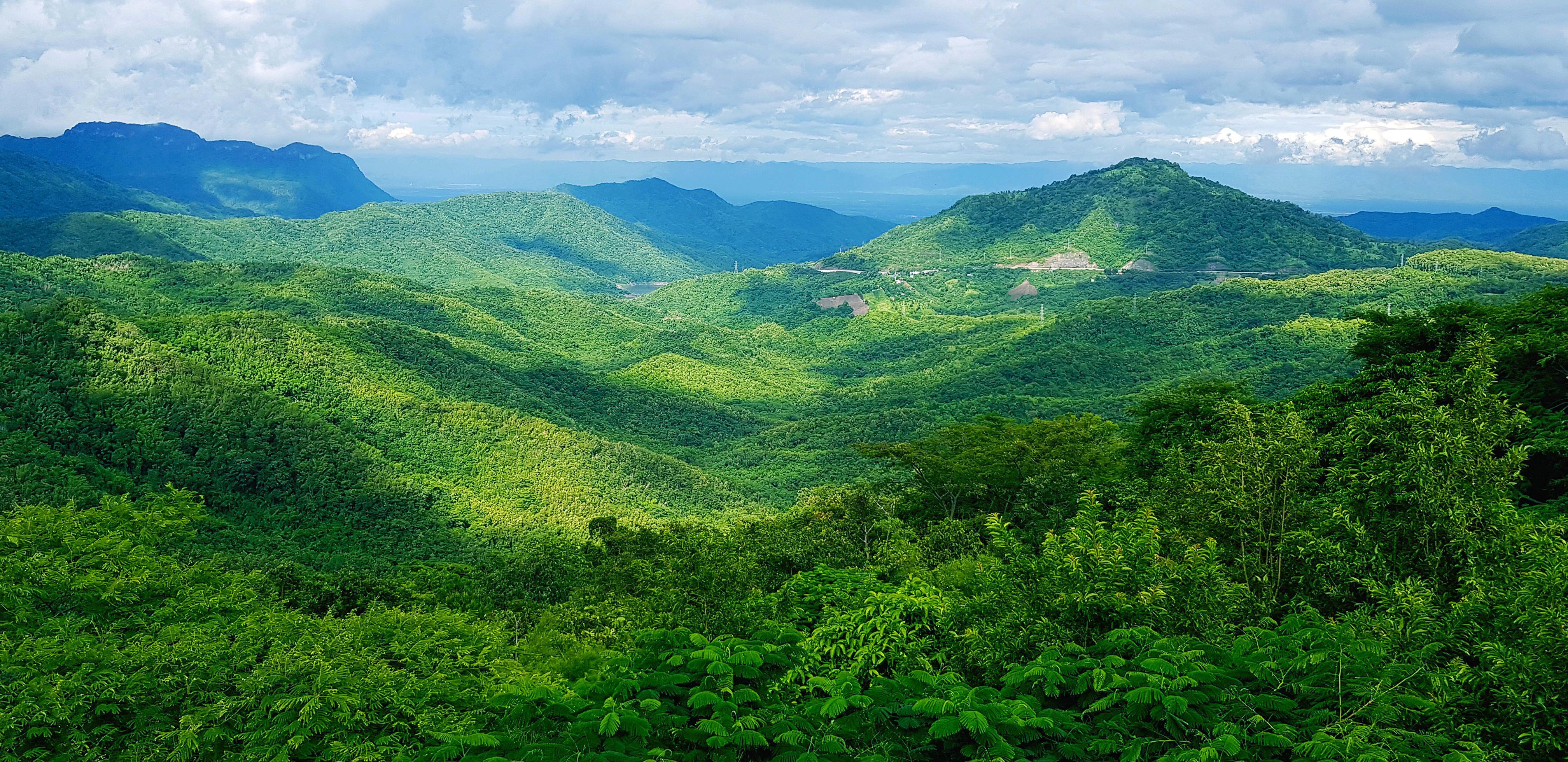 Beautiful landscape of mountain. Green forest or deep jungle with mountain heel and cloud sky. Beauty of nature and Natural wallpaper concept Stock Free