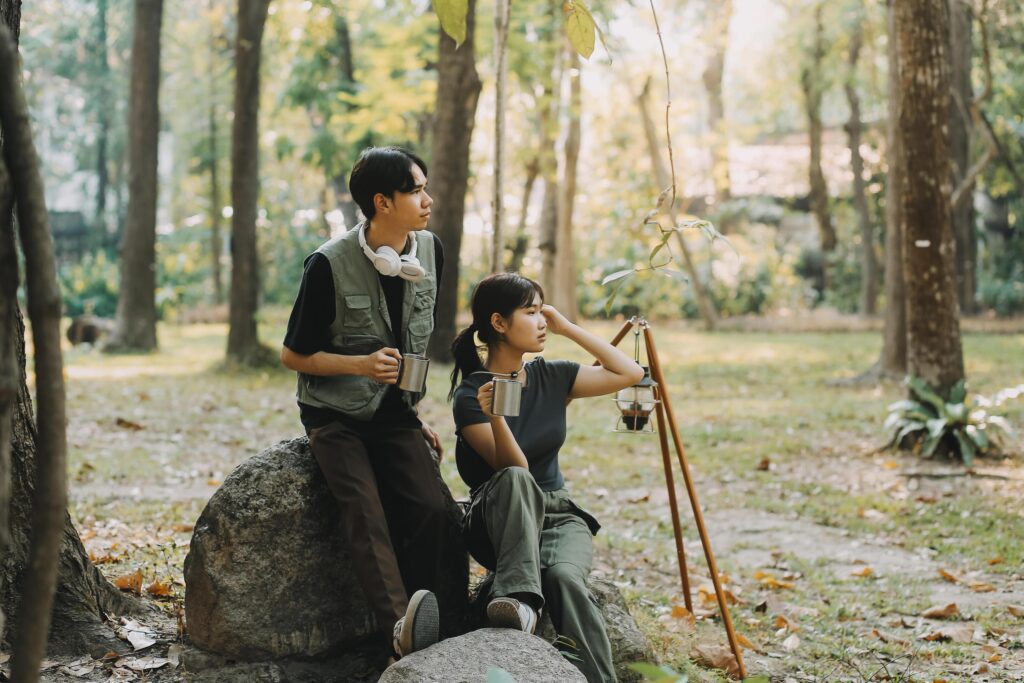 Asian couple sweet in tent inside on they camping trip, traveller relax and sleep togather in out door and camping trip Stock Free