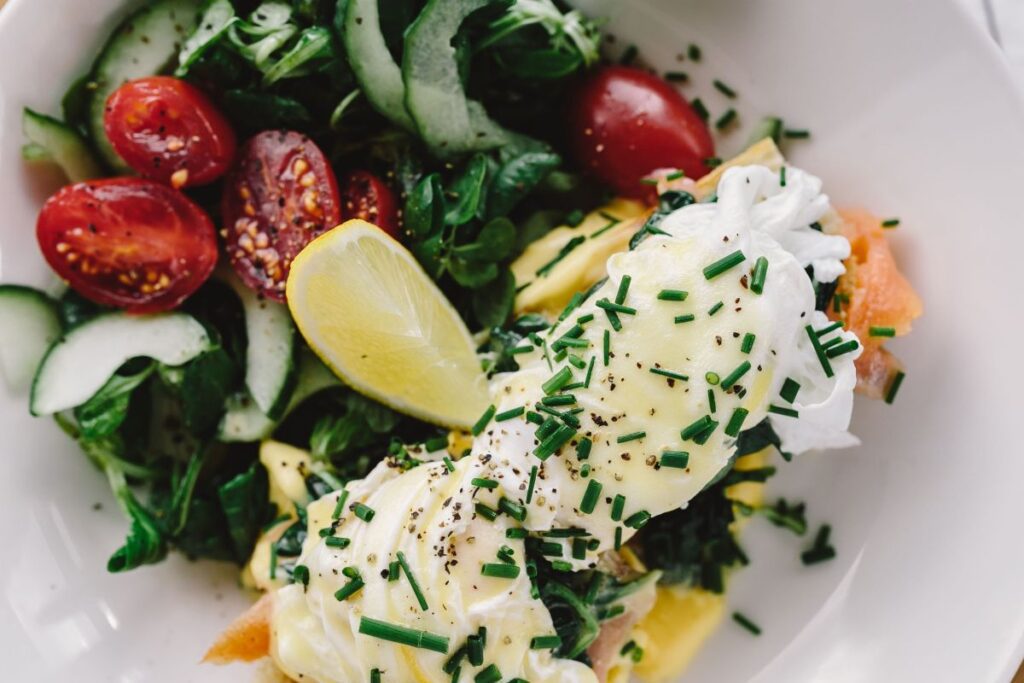 Close up image of young woman eating classic breakfast at restaurant Stock Free