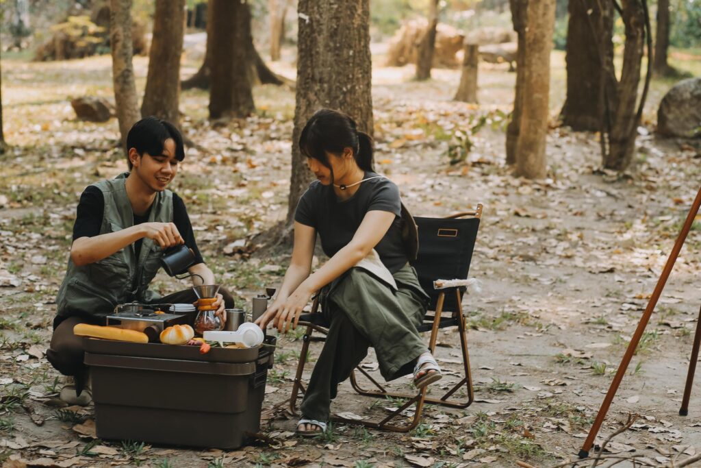 Asian couple sweet in tent inside on they camping trip, traveller relax and sleep togather in out door and camping trip Stock Free