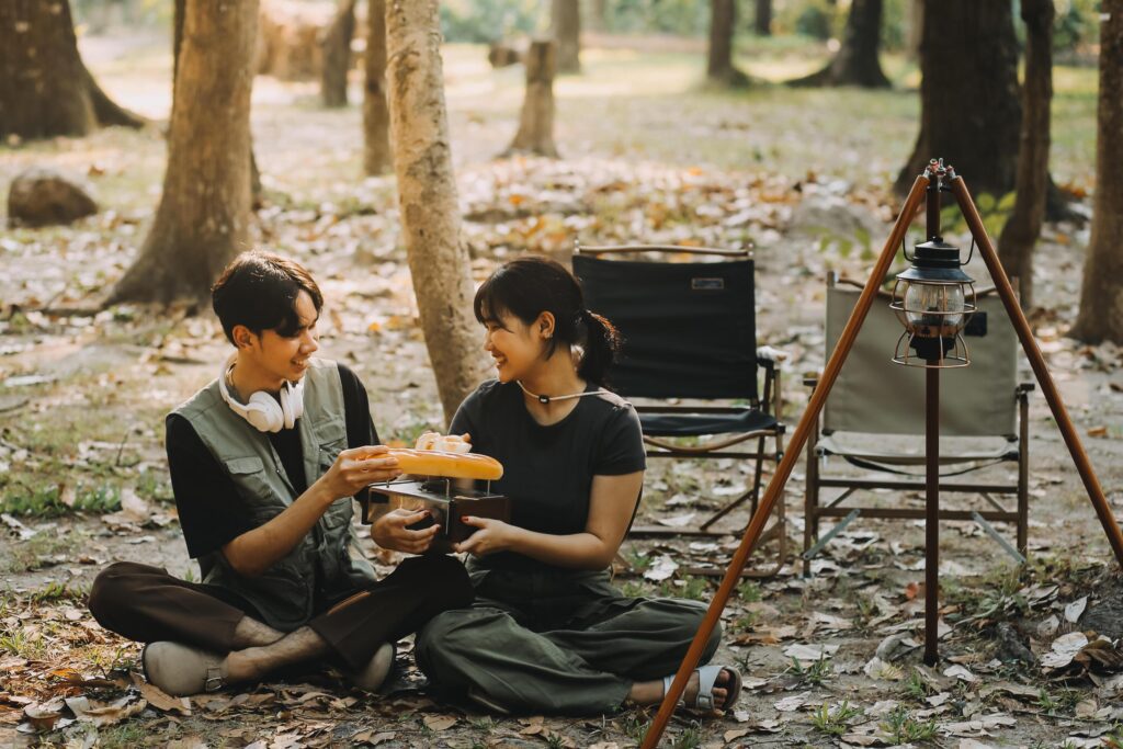 Asian couple sweet in tent inside on they camping trip, traveller relax and sleep togather in out door and camping trip Stock Free