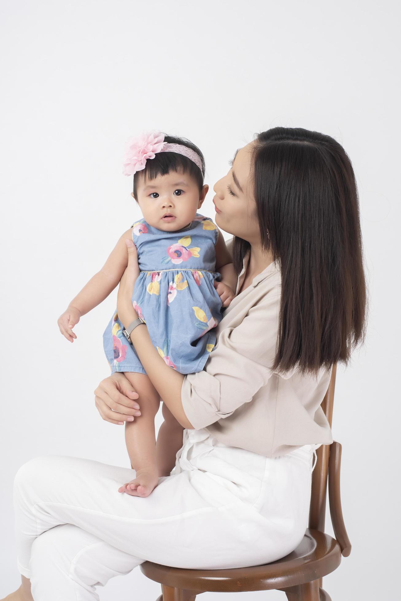 Asian mother and adorable baby girl are happy on white background Stock Free