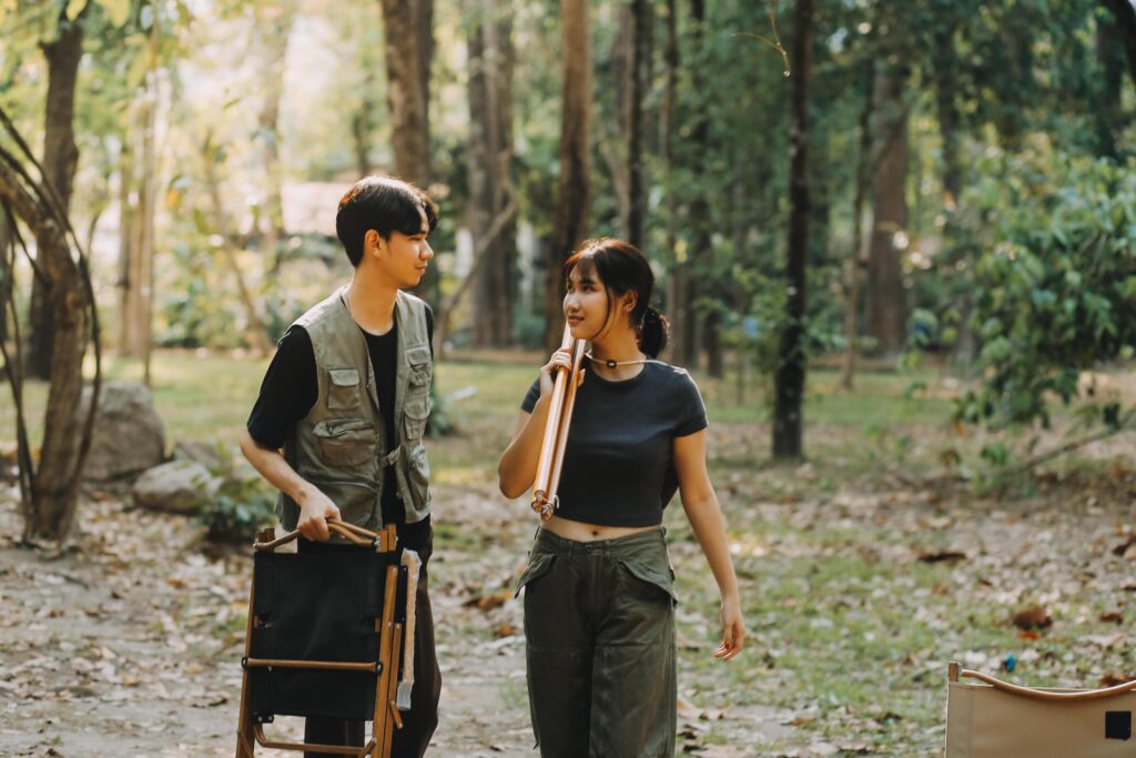 Asian couple sweet in tent inside on they camping trip, traveller relax and sleep togather in out door and camping trip Stock Free