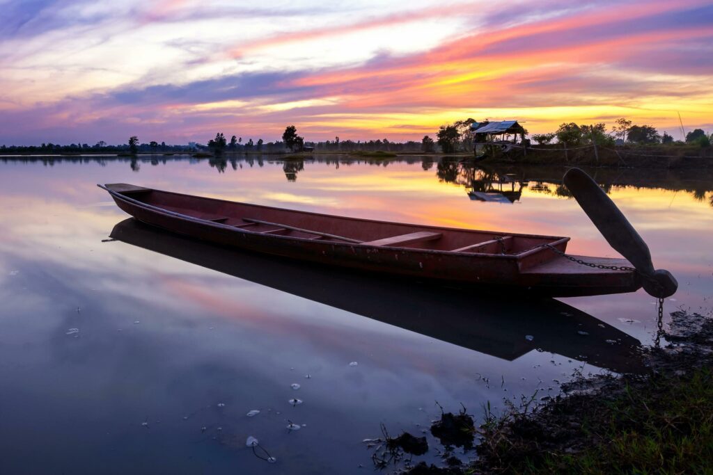 Boat on the lake with sunset background Stock Free