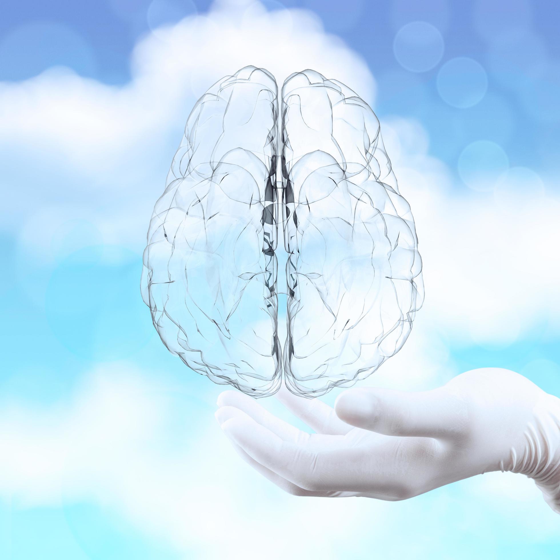 medical doctor hand showing 3d glass human brain on nature background as concept Stock Free