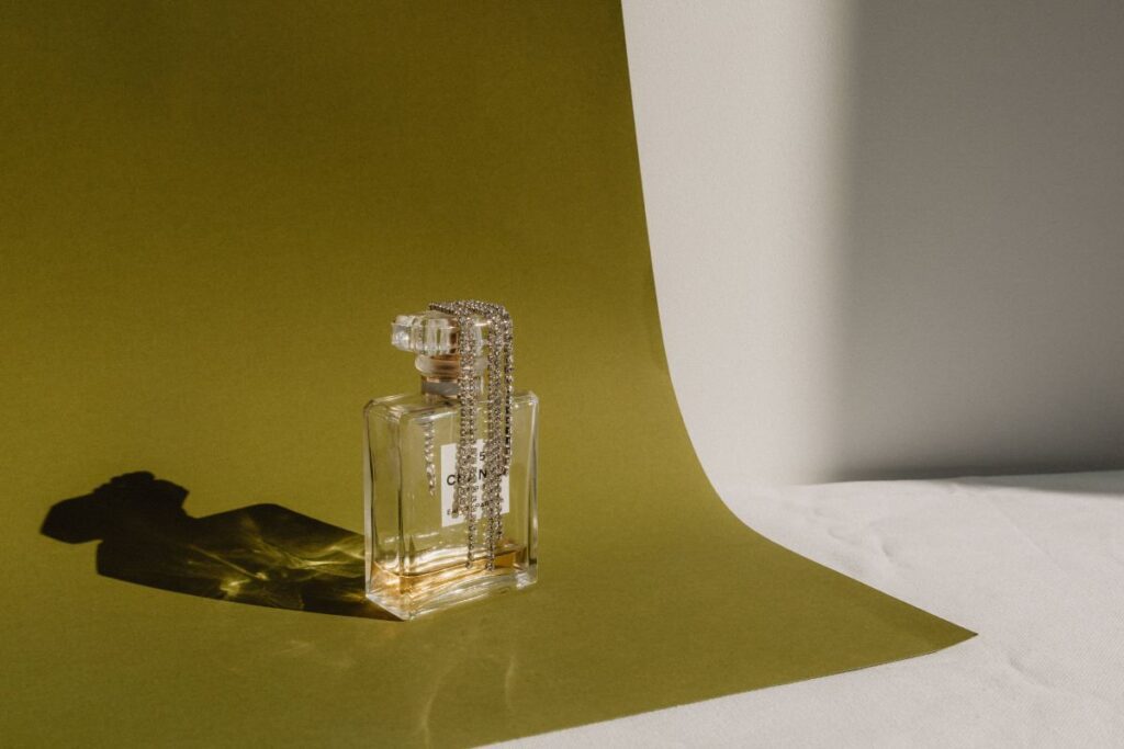 Refined Aromas: Perfume Bottles Cast in Shadows and Light Stock Free