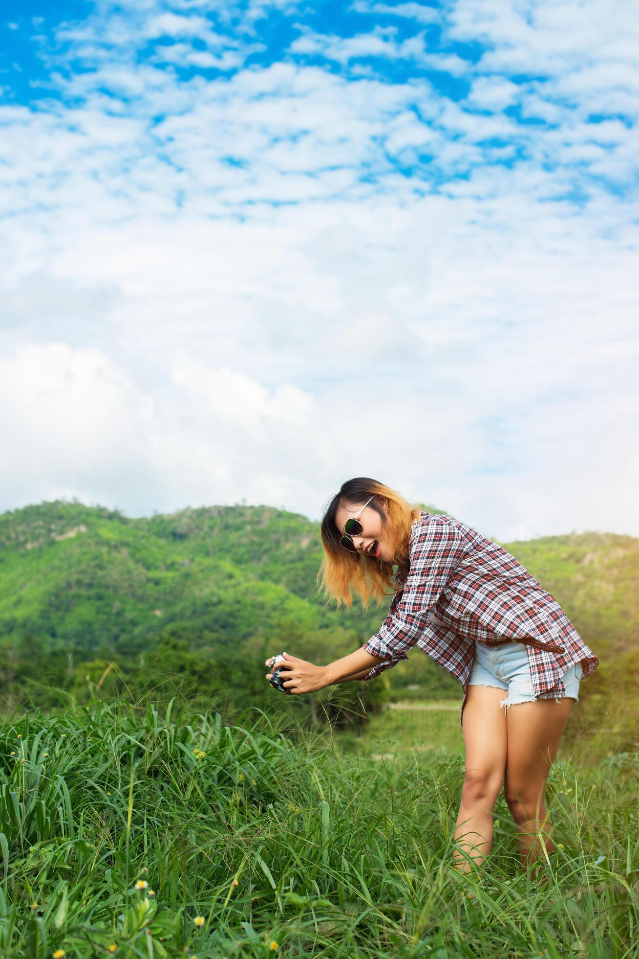 Young Hipster Woman with retro camera taking shot outdoor landscape ,Lifestyle mountain nature on background. Stock Free