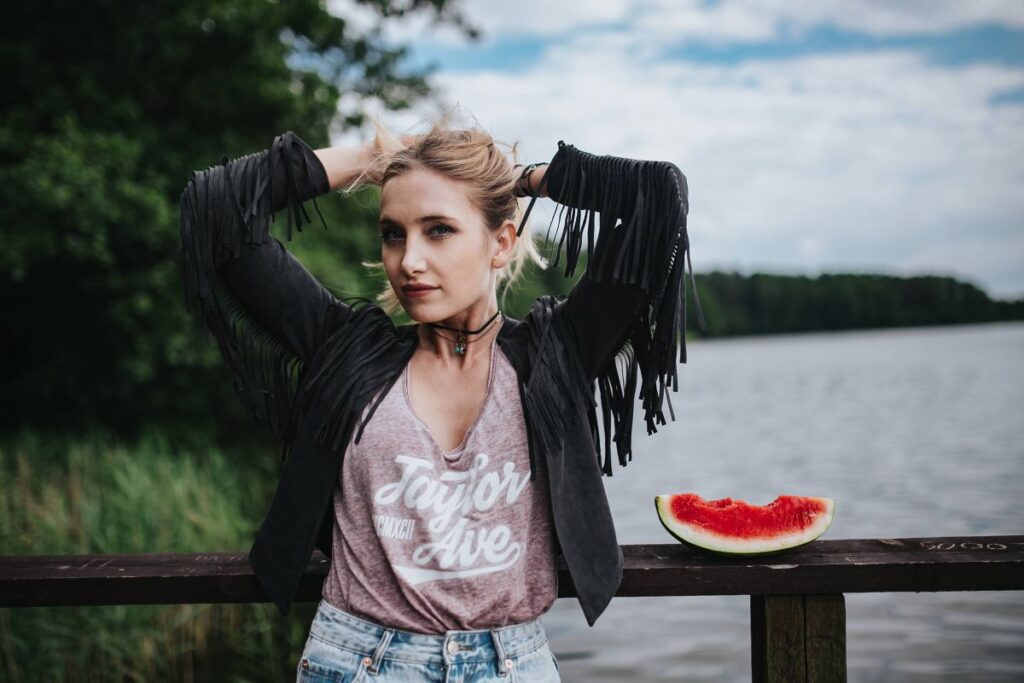 Blonde woman having a healthy snack at the wooden pier Stock Free