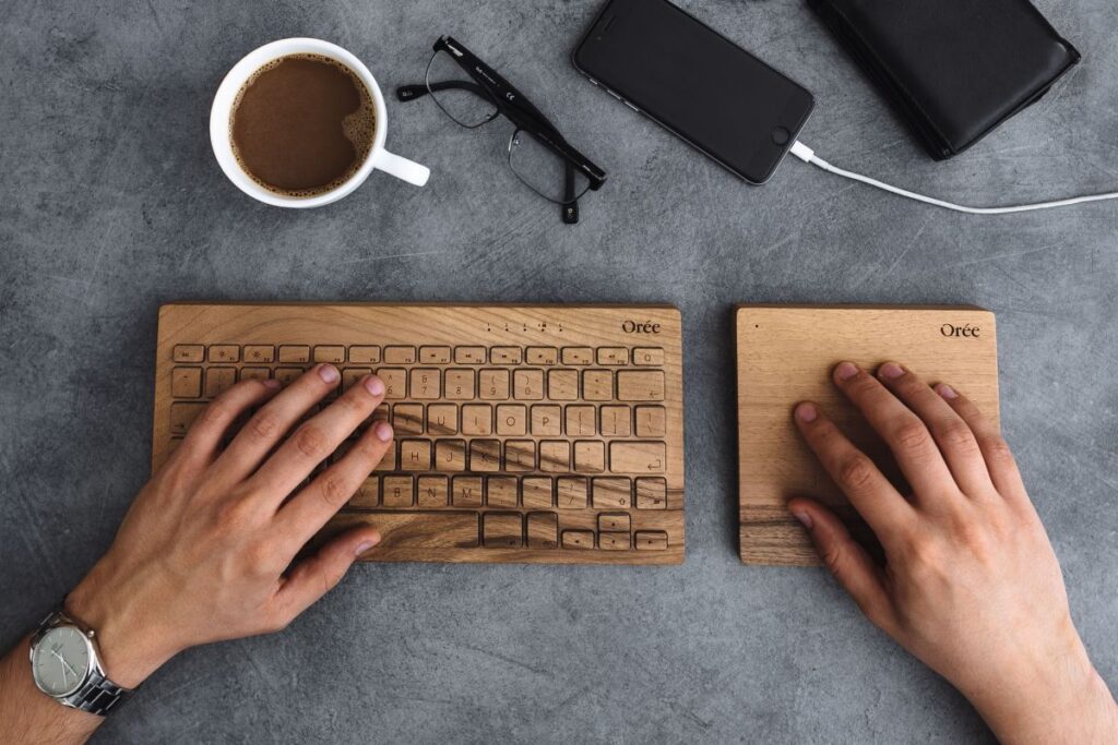 Young man typing on the wooden keyboard Stock Free