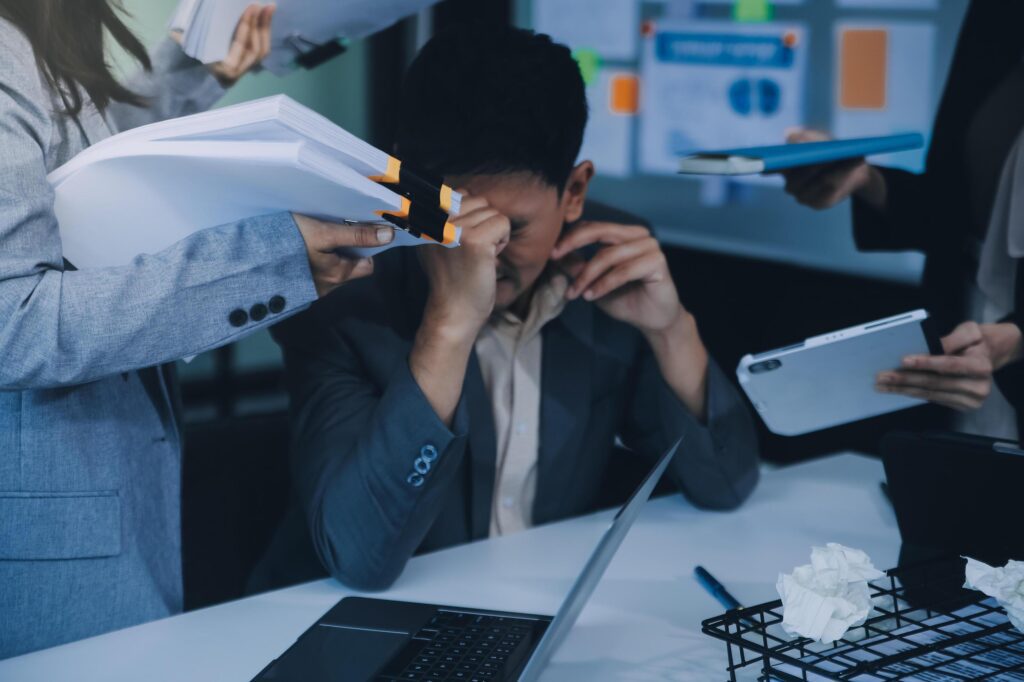 Stressful business man have so many paperwork in the office Stock Free