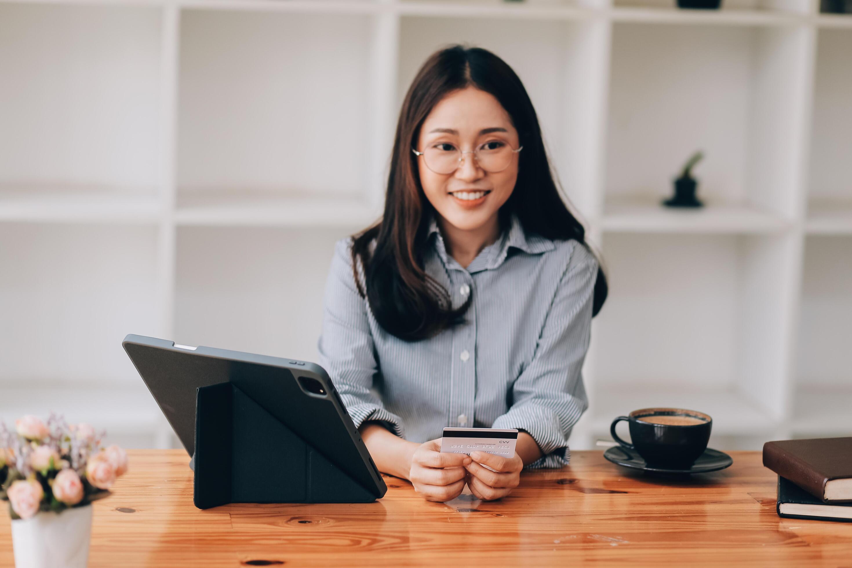 Happy asian woman using smartphone shopping online with credit card. Lifestyle. Easy pay using smart phone or digital device. Stock Free