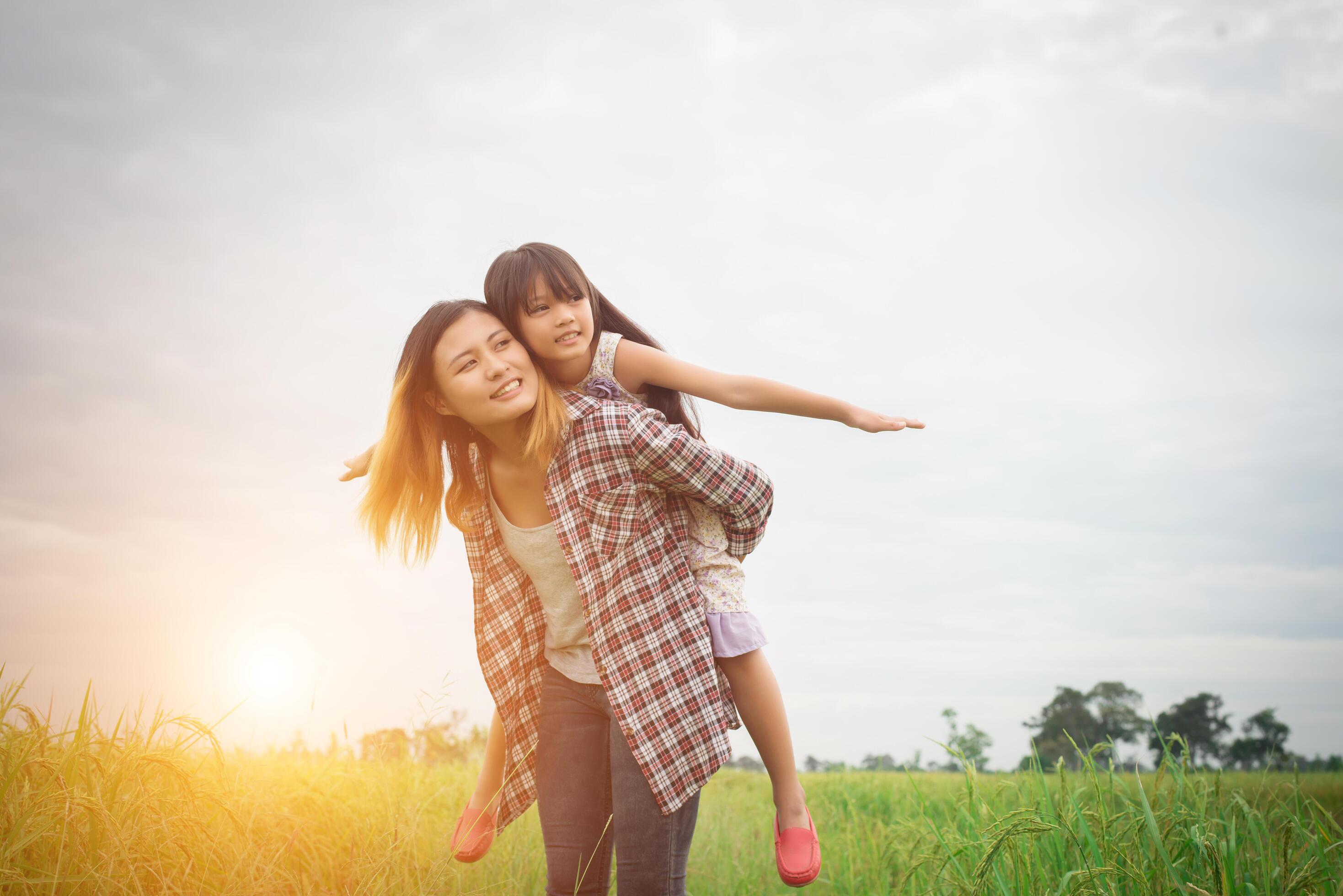 Portrait mom and daughter playing outdoor, enjoying family time. Stock Free