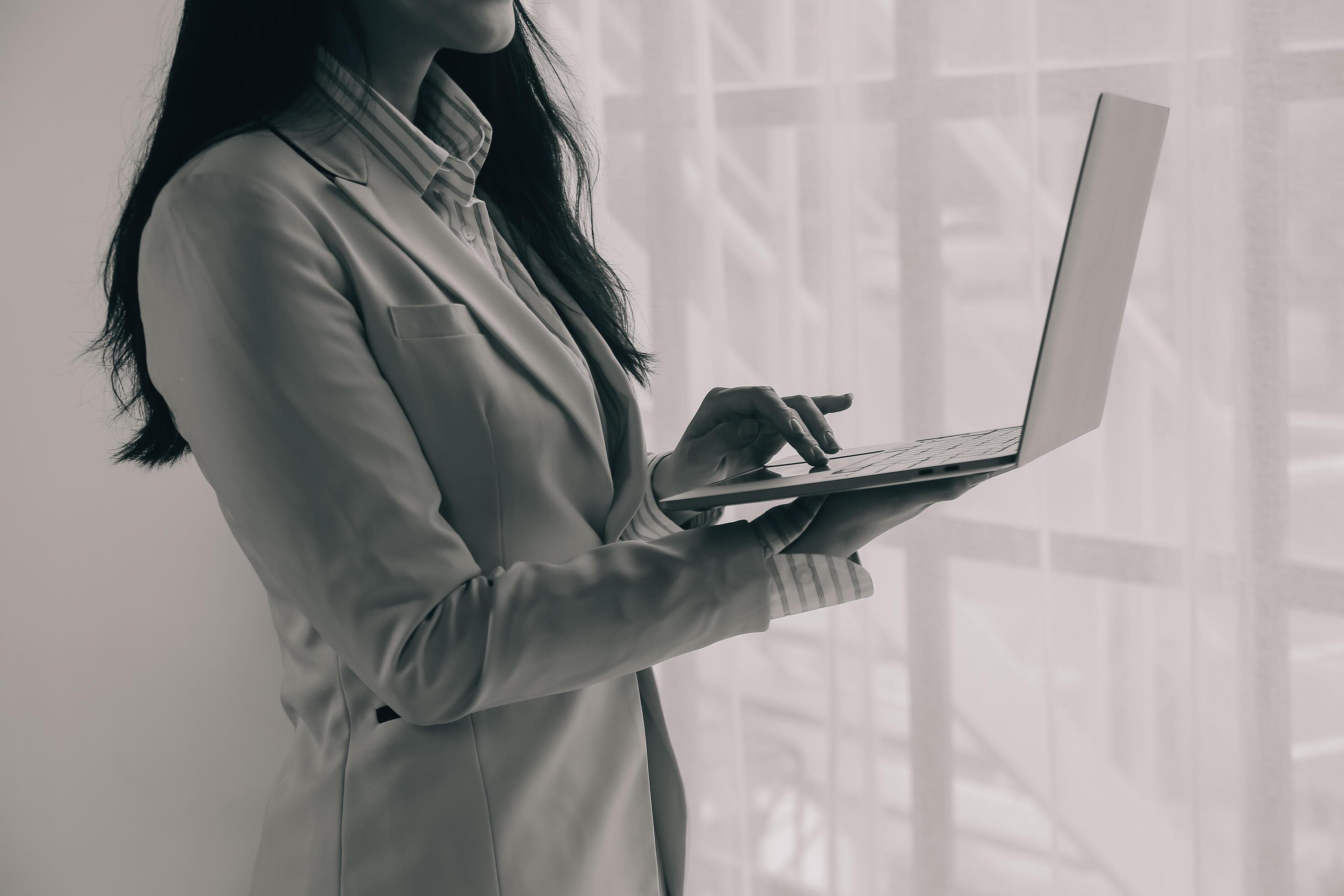 Cropped image of young asian businesswoman working on laptop computer at office. Business lifestyle, successful business concept. Stock Free