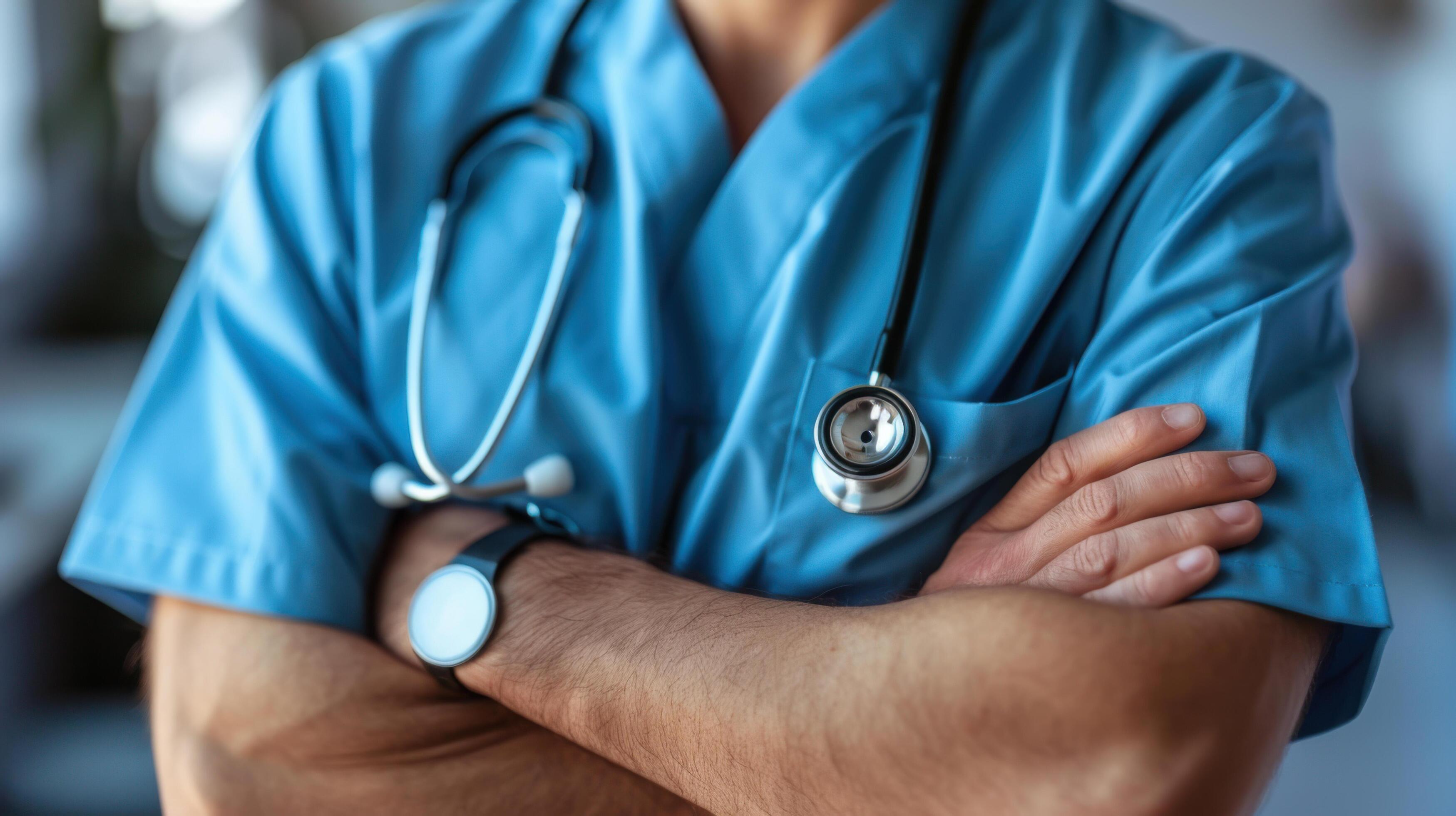 Close-up of a doctor with a stethoscope and arms crossed, symbolizing healthcare professionalism and medical expertise. Stock Free